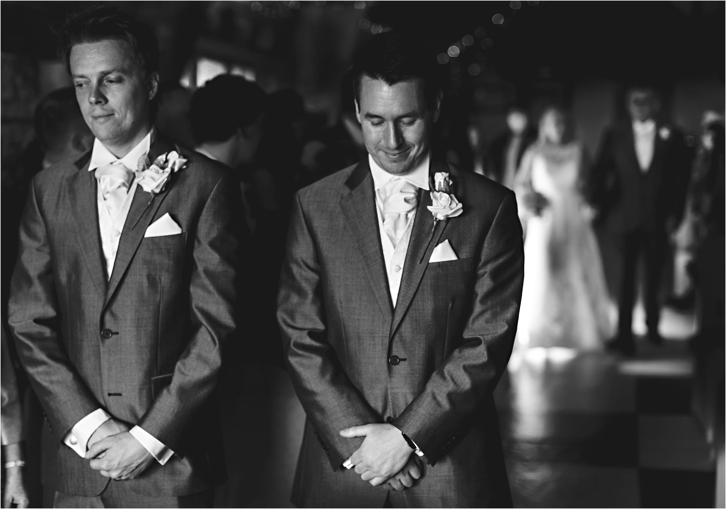 the groom waiting at the front of the isle for his bride