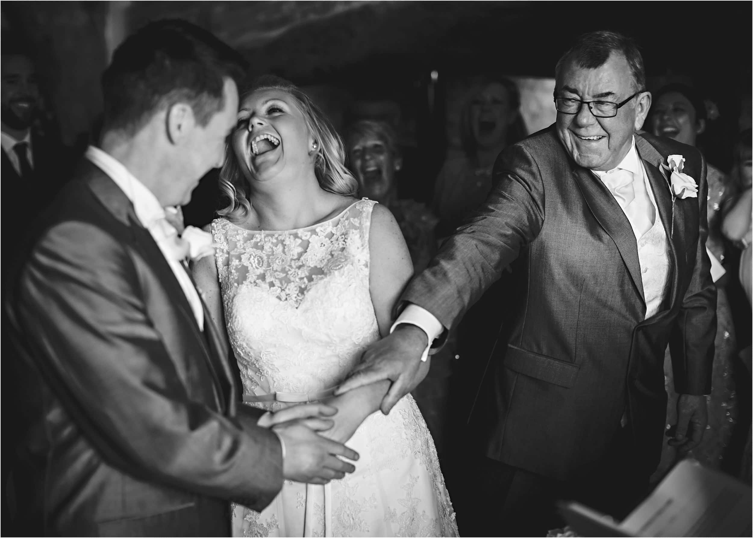 father of the bride giving his daughter away and laughing