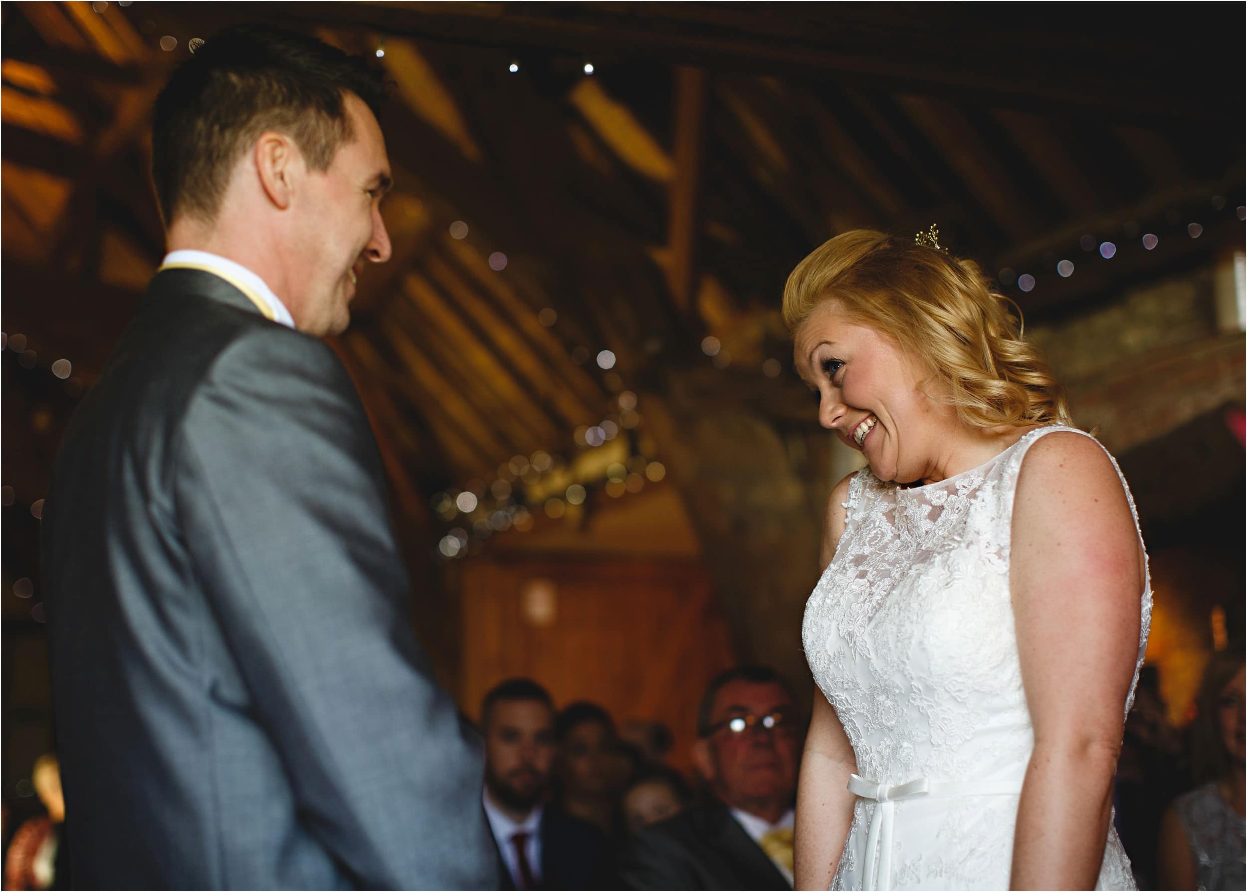 smiling at the front of the ceremony