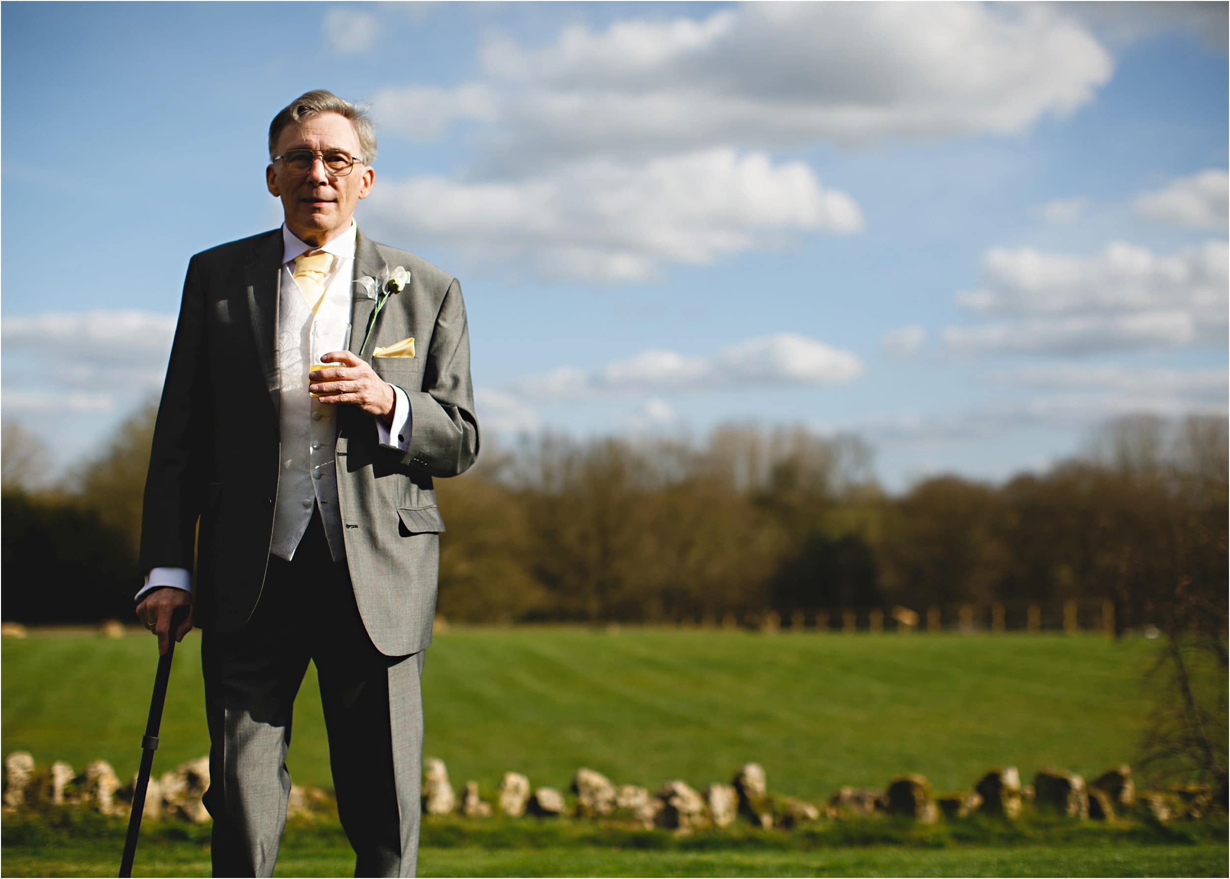 dad stood in a field holding a drink
