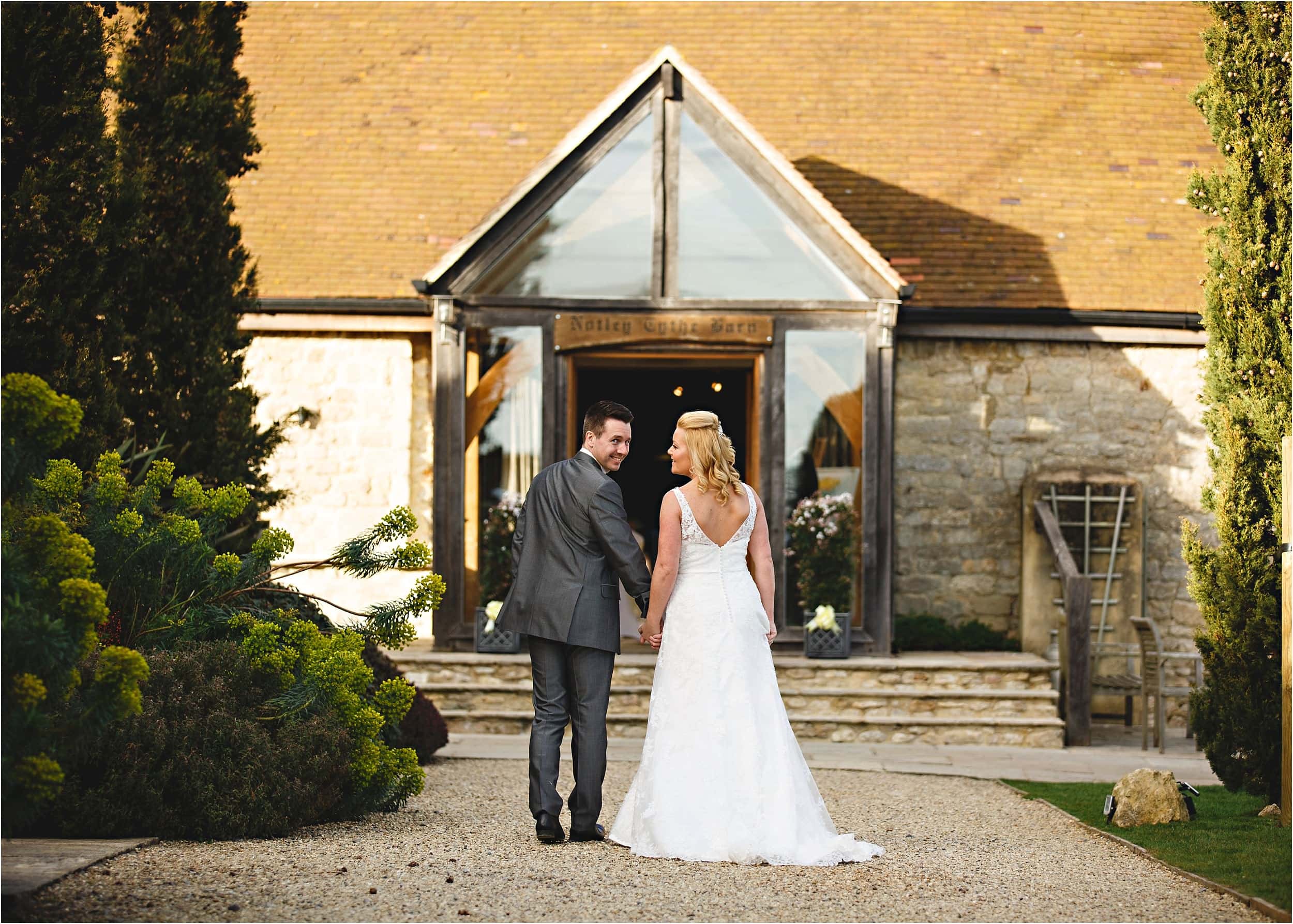 the bride and groom walking into the wedding venue for their meal