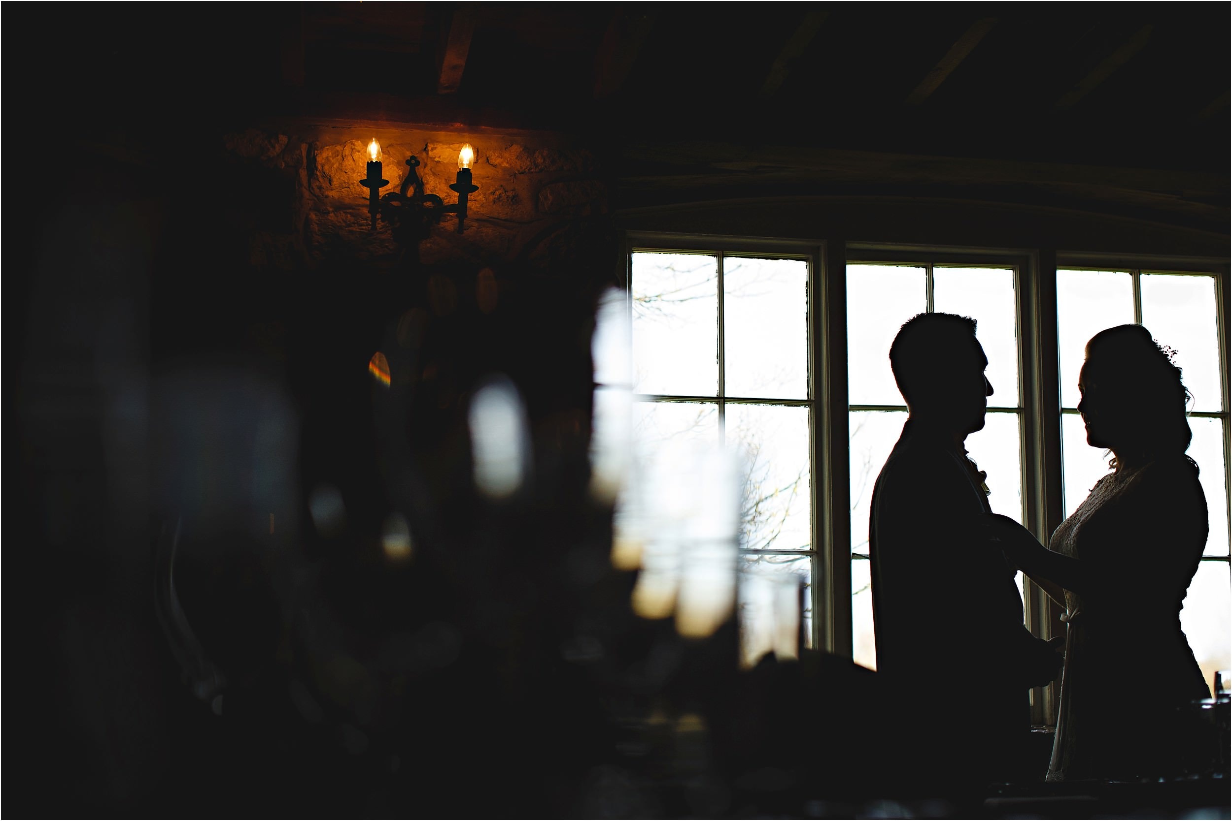 bride and groom stood in the window 