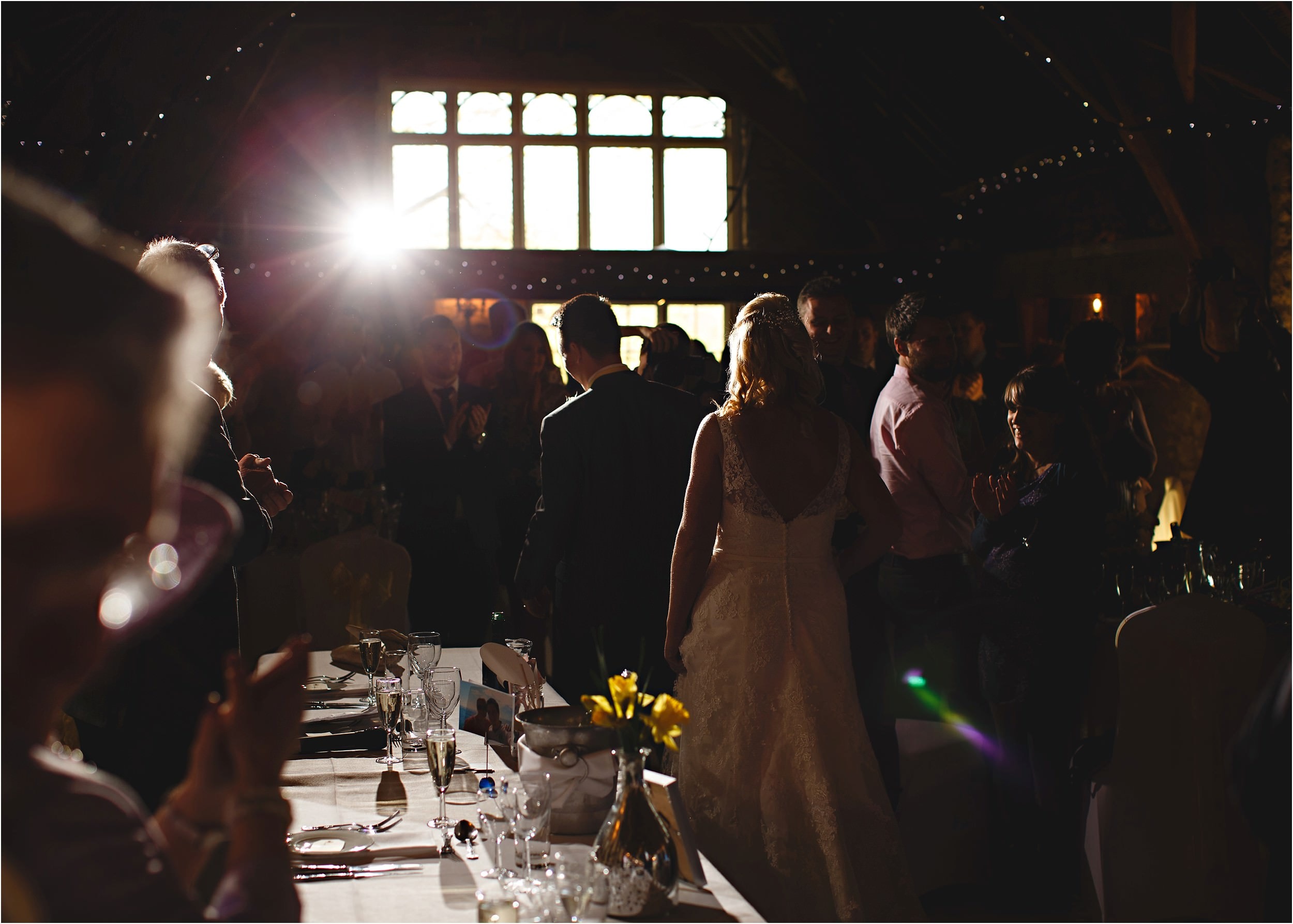the bride and groom entering the wedding breakfast
