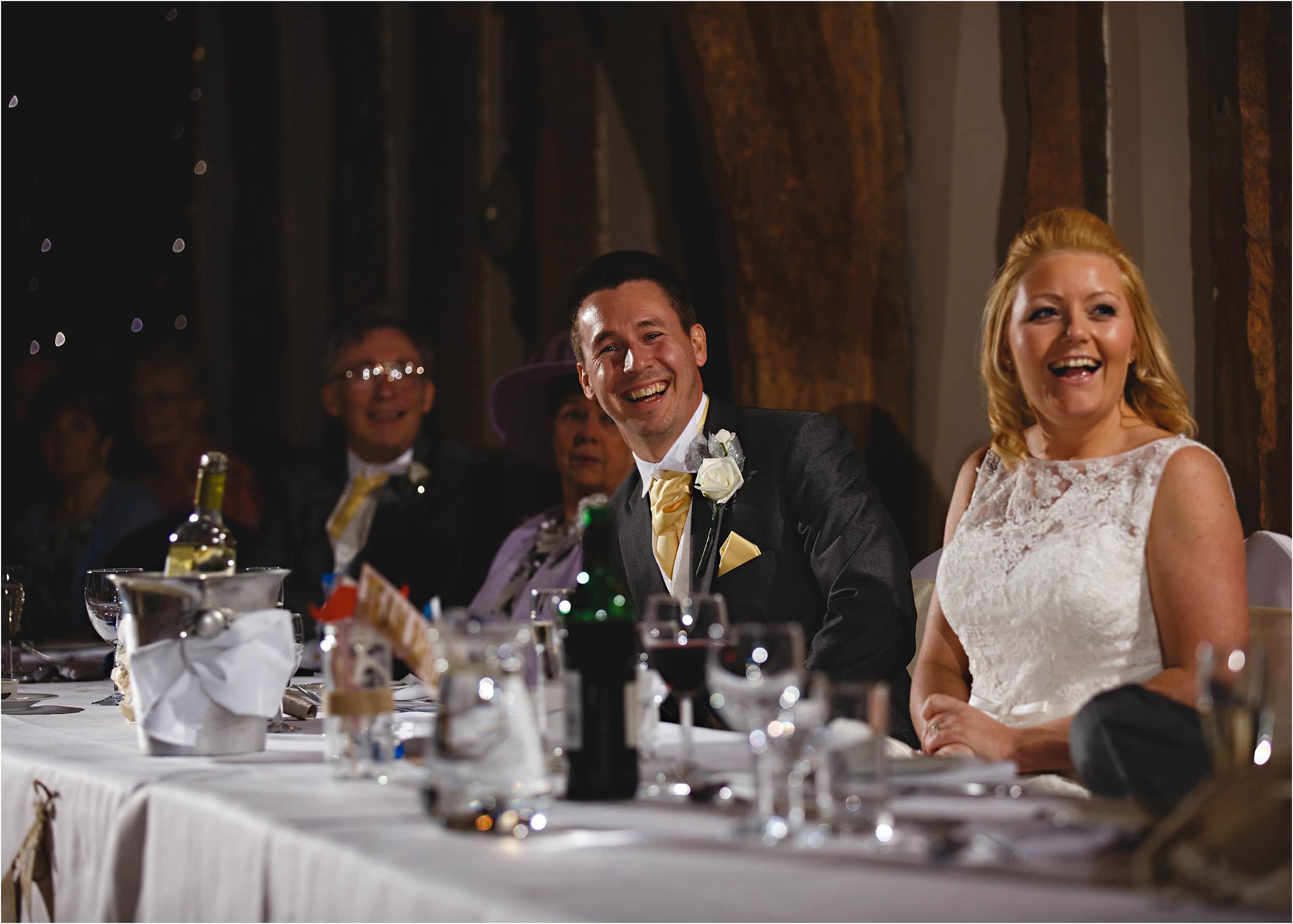 the groom laughing at the best mans speech