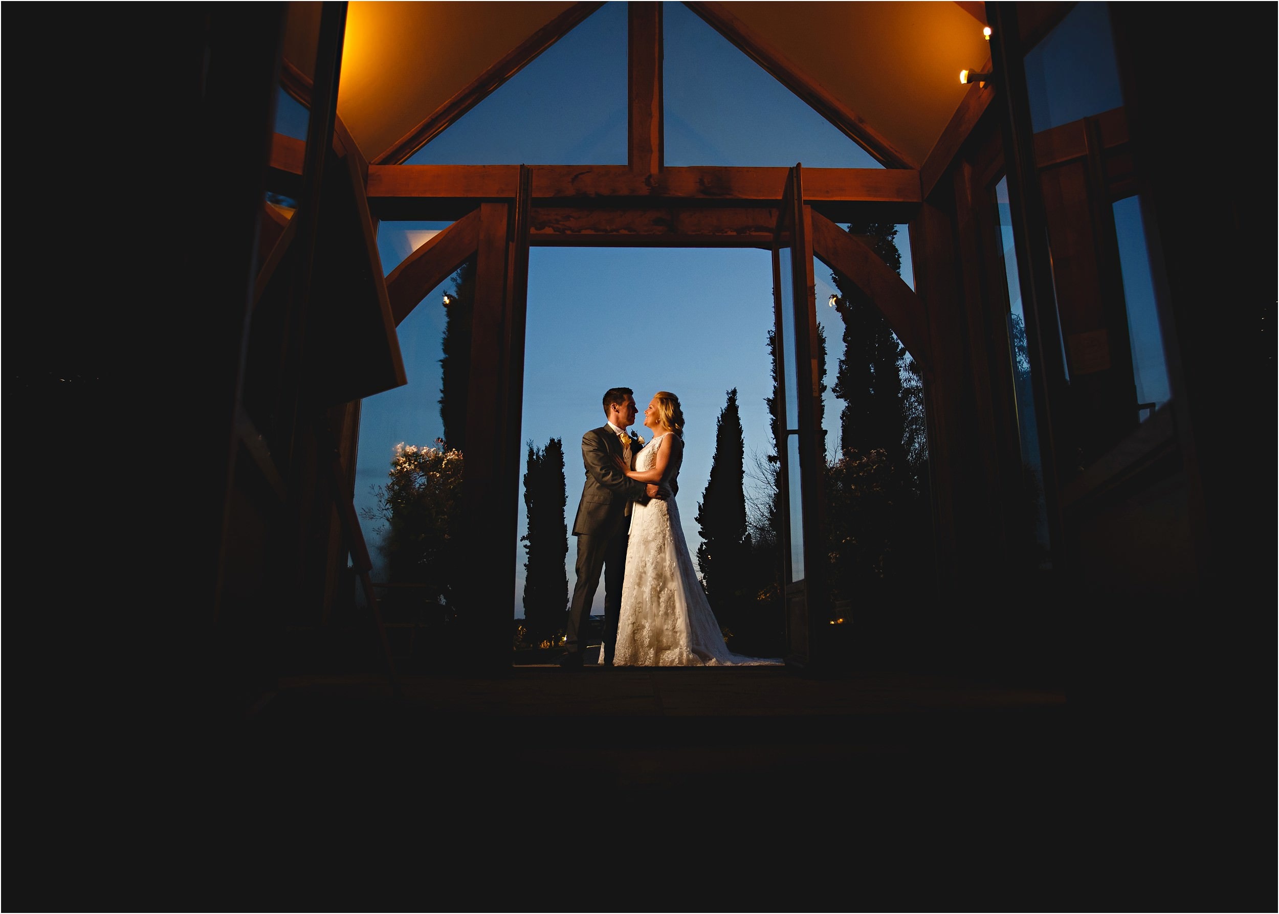a dark photo of the bride and groom stood outside the wedding venue