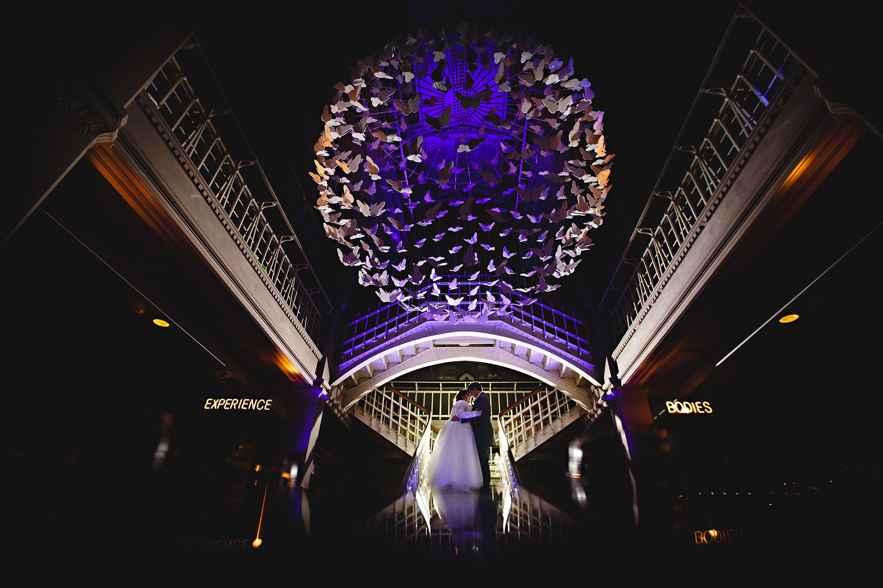 the bird eand groom stood in manchester museum for their wedding photos