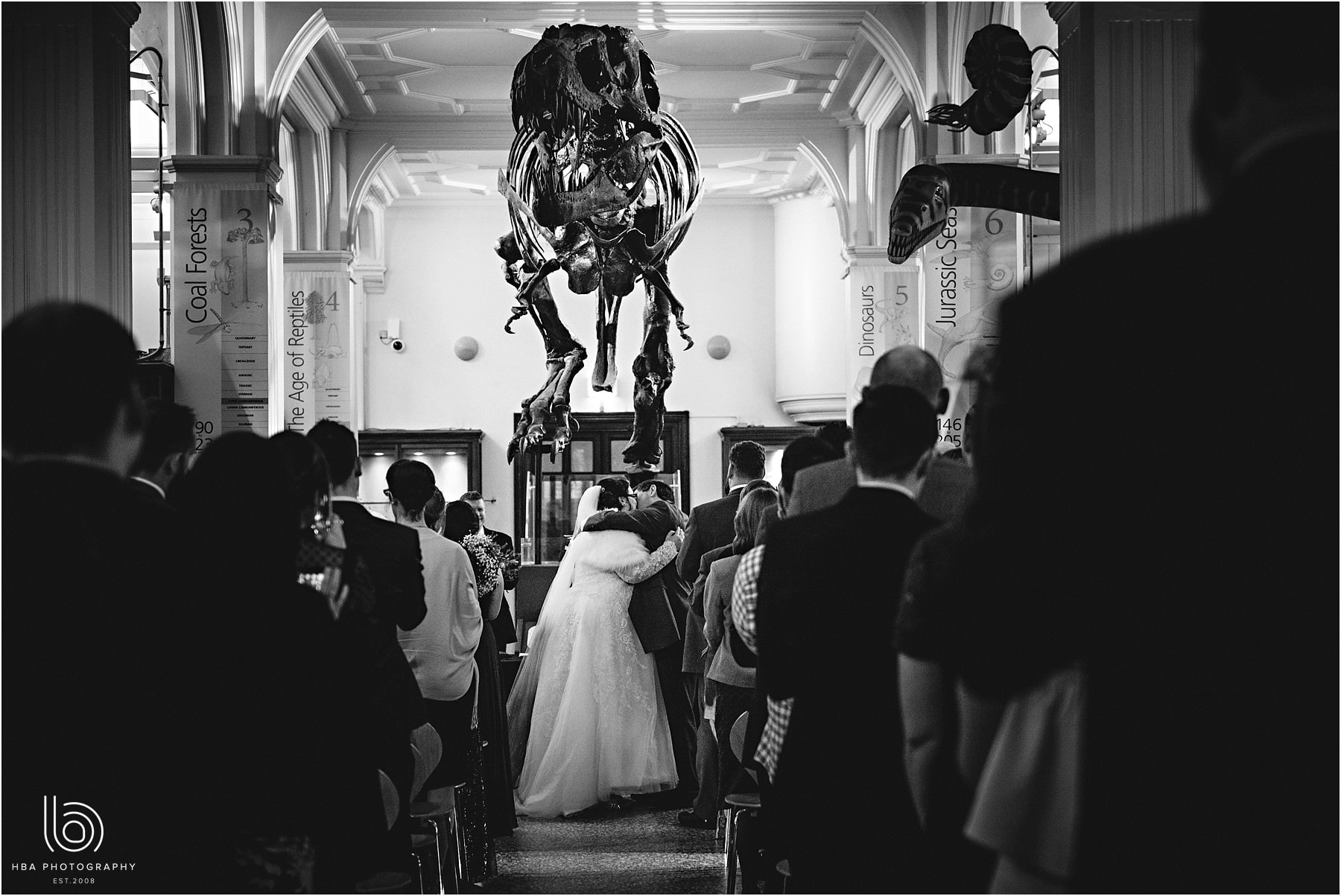 the bride & groom with the dinosaur