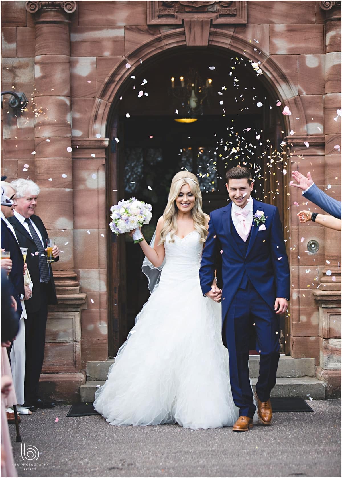 the bride and groom getting covered in confetti
