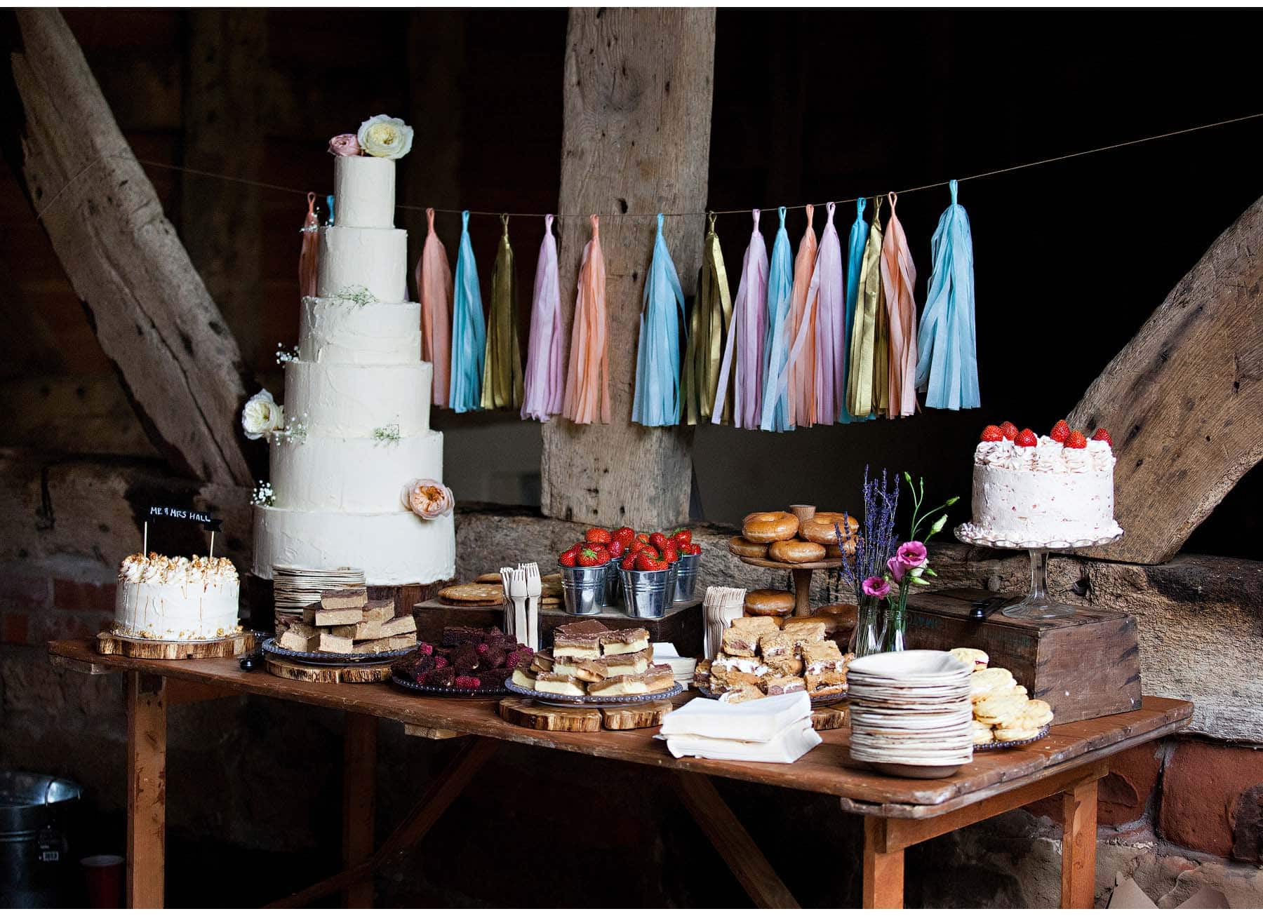 The wedding cake table, with doughnuts, brownies and strawberries