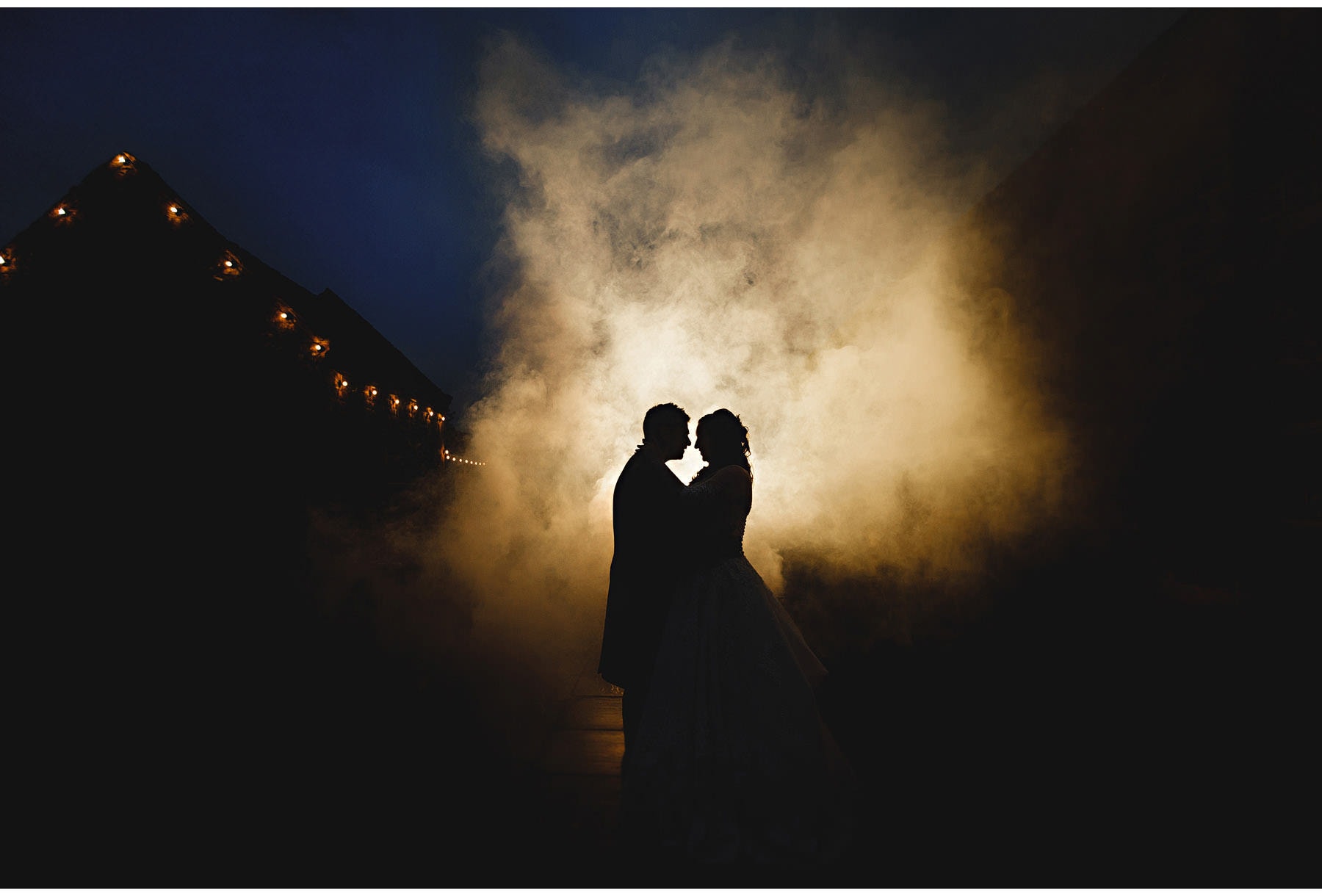 The bride & groom in the mist at night