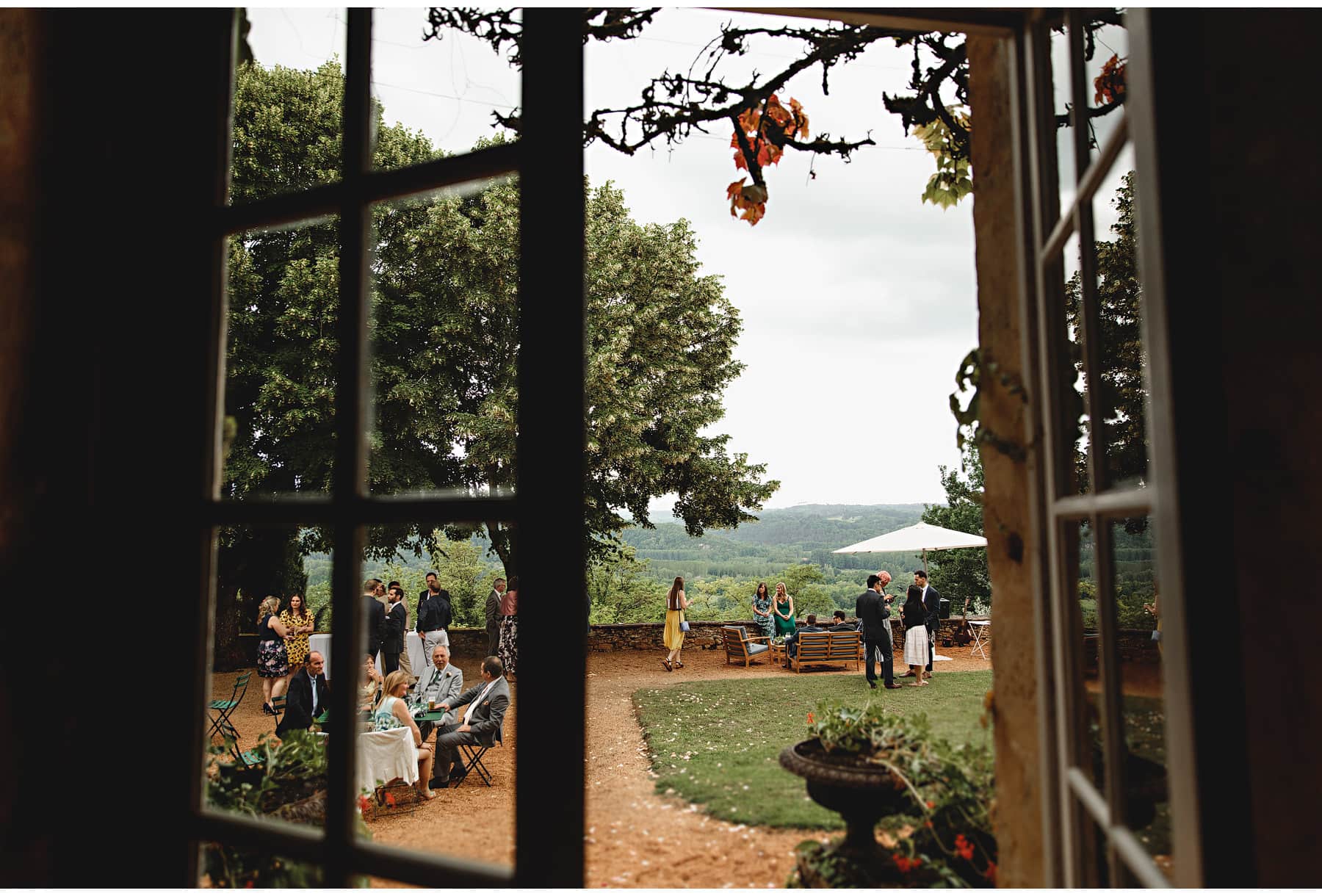 Looking through the window at guests enjoying the wedding reception