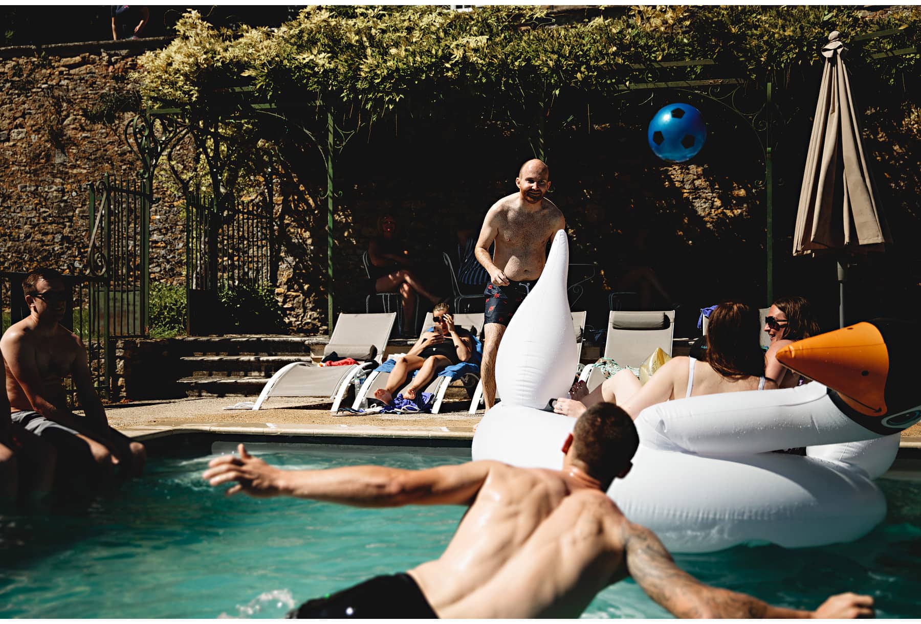 the groom playing in the pool the day after the wedding