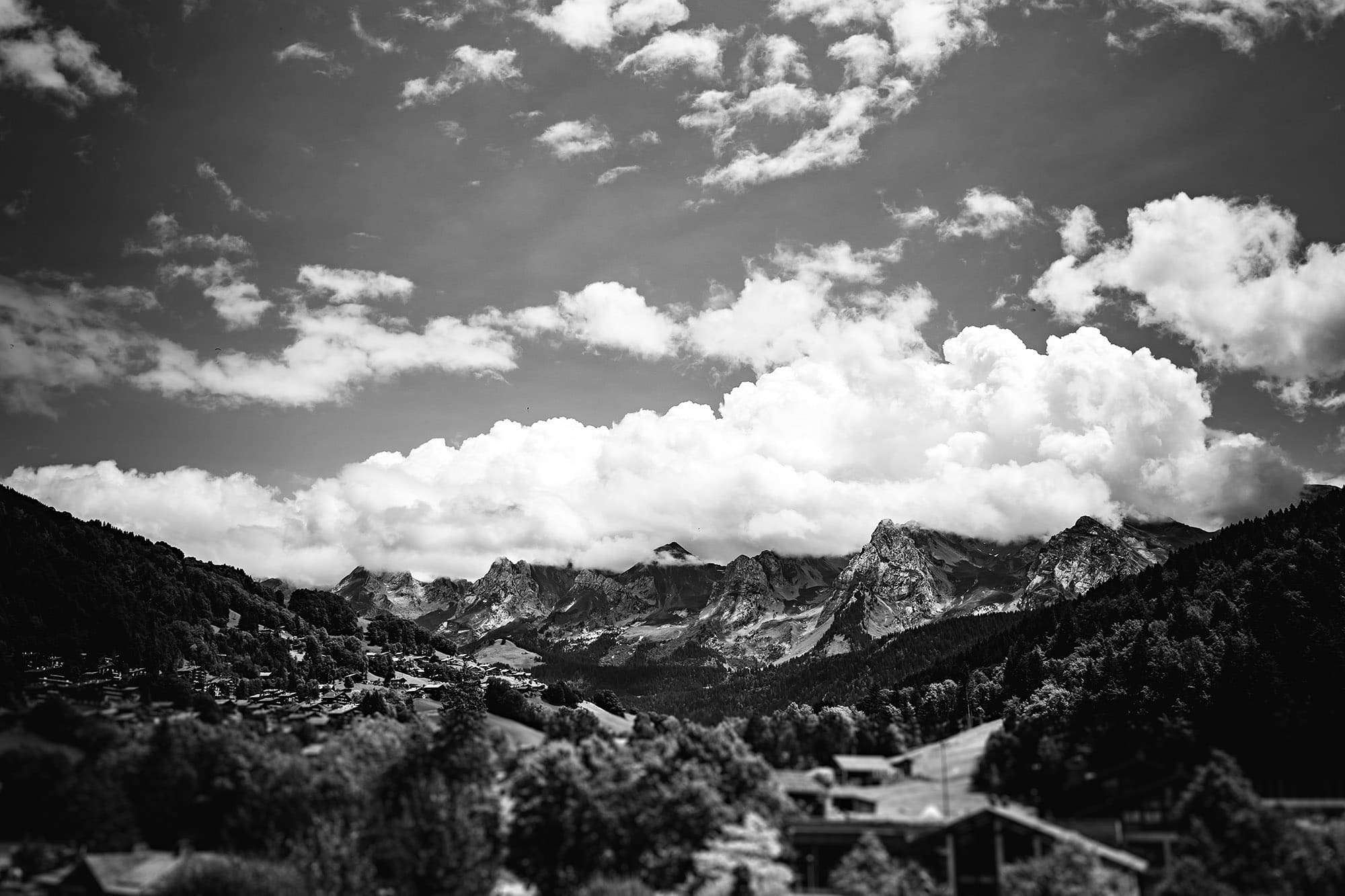 A black and white wedding photo capturing the majestic French Alp mountains in France.