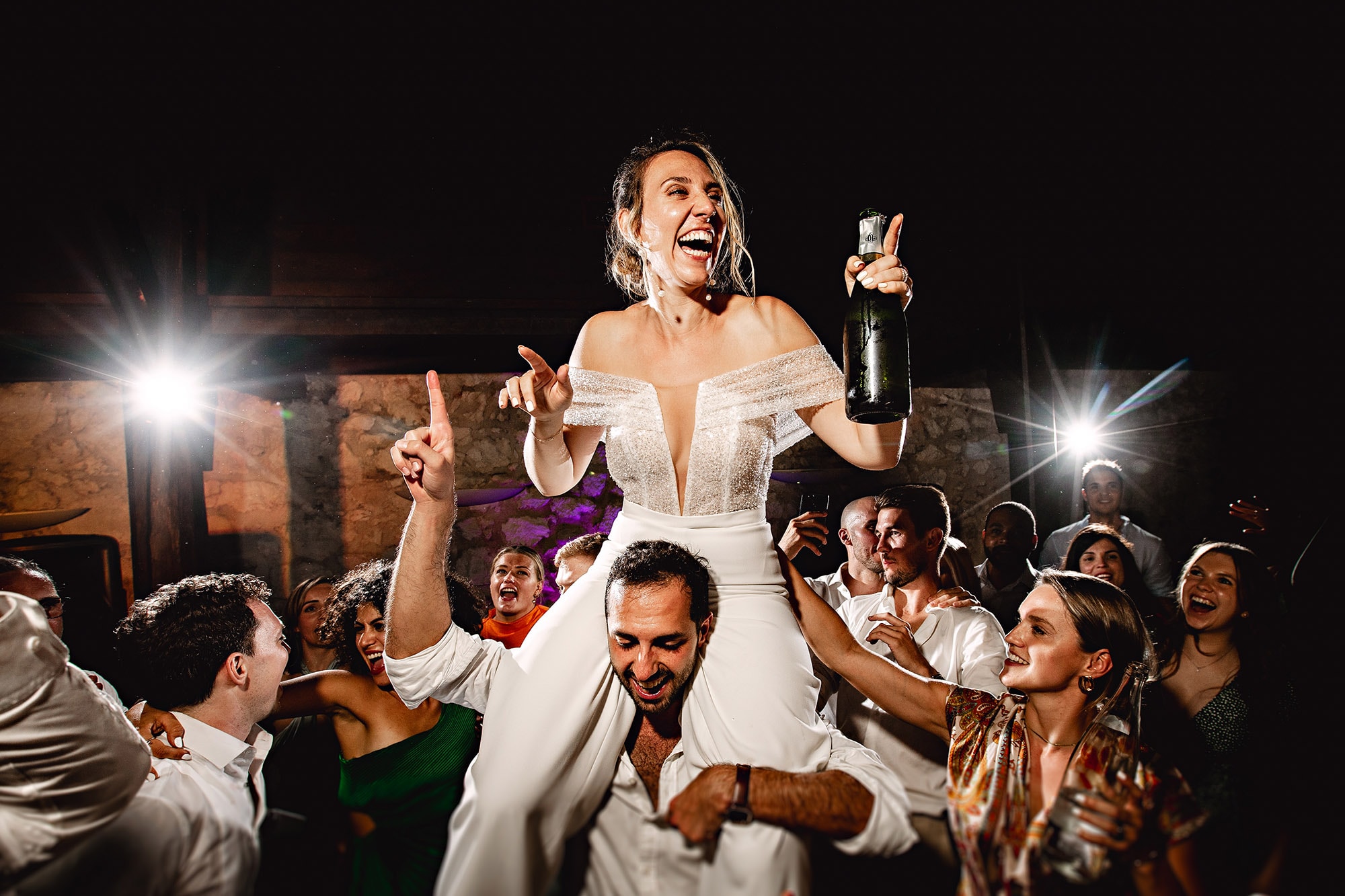 A bride is being photographed by an Annecy wedding photographer on the dance floor.